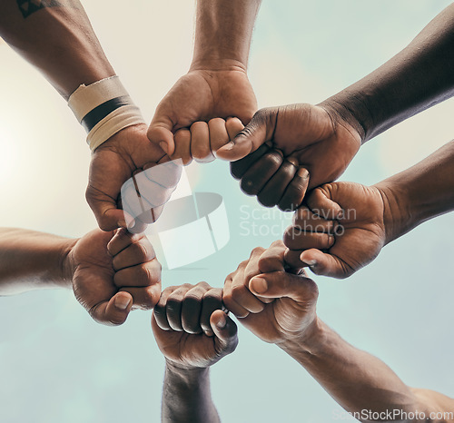 Image of Hands, fist and unity with a sports team standing in a huddle for solidarity or motivation before a game. Fitness, teamwork and diversity with a group of men in a circle, getting ready for a match