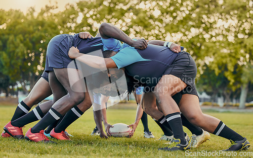 Image of Scrum, sports and men playing rugby, catching a ball and preparing for a game on the field. Ready, together and competitive players scrumming for the start of a sport competition with contact