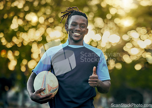 Image of Rugby, thumbs up and portrait of black man with ball, confidence and pride in winning game. Fitness, sports and happy face of player ready for match, workout or competition at stadium in South Africa