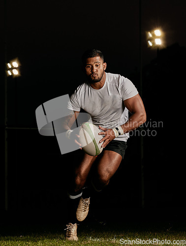 Image of Rugby, night and man running with ball to score goal at dark stadium at game, match or practice workout. Sports, fitness and motion, player with action on grass with energy and skill in team sport.