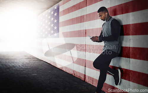 Image of Music, phone and black man runner relax against an American flag background during training run outdoors. Online, podcast and search by male athlete browse, chill and browse after workout in the USA