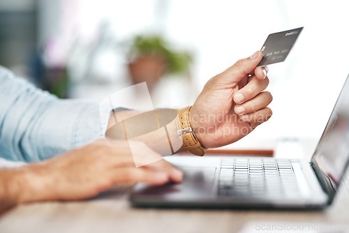 Image of Man, hands and laptop with credit card for online shopping, ecommerce or wireless transaction on desk. Hand of male on computer for internet banking, app or financial purchase or payment on table