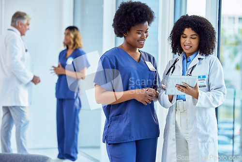 Image of Tablet, medical or collaboration with a doctor and nurse talking in the hospital while doing research. Healthcare, teamwork and trust with professional colleagues in medicine working in a clinic