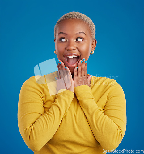 Image of Black woman, happy and surprise face in studio for fashion, youth or notification by blue background. Young african girl, model or happiness with excited wow, announcement or deal with hands by mouth