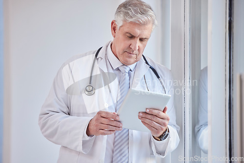 Image of Doctor, tablet and senior man in hospital for research, telehealth or online consultation. Healthcare, technology and elderly medical professional with touch screen for wellness app in health clinic.