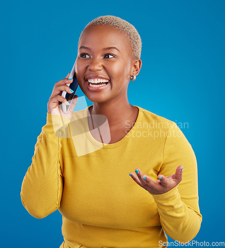 Image of Phone call, excited and black woman talking in studio for social network, connection and conversation. Communication mockup, smartphone and surprised girl speaking, smile and chat on blue background