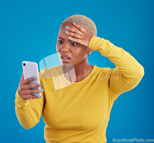Image of Wtf, phone and confused black woman in studio for fake news, social media and text on blue background. Omg, scam and girl with smartphone notification for phishing alert, glitch or internet problem