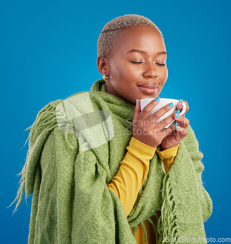 Image of Coffee, scent and a black woman on a blue background in studio smelling the aroma for her mug. Relax, drink and easy with an attractive young female enjoying a fresh cup of caffeine during a break