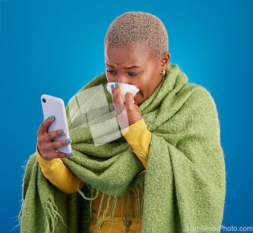 Image of Sick black woman, phone and blowing nose on background, studio and allergies from winter virus. Female model, influenza and smartphone for telehealth app, covid healthcare and search symptoms online