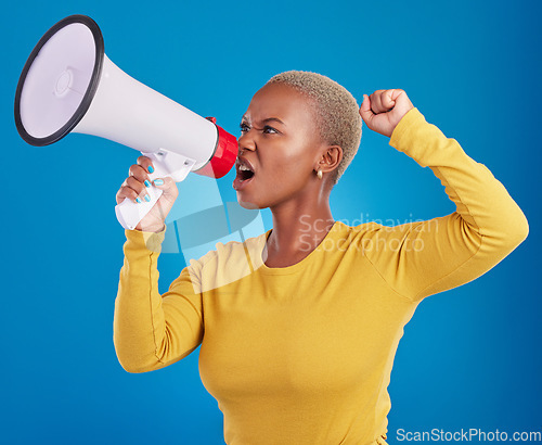 Image of Megaphone, black woman and screaming in studio with fist of power, broadcast or vote on blue background. Speaker, microphone and girl protest for change, democracy or justice, noise or womens rights