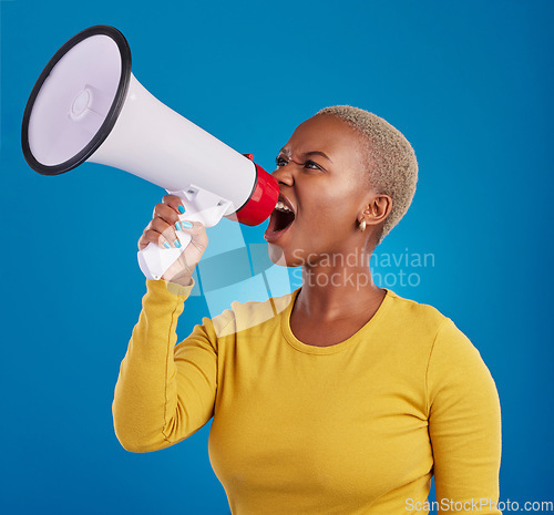 Image of Megaphone, shouting and angry black woman in studio for message, broadcast or vote on blue background. Speaker, microphone and girl protest for change, democracy and justice, noise and womens rights