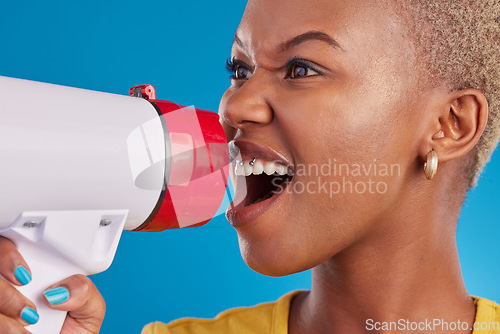 Image of Megaphone, shouting and face of black woman in studio for message, broadcast or vote on blue background. Speaker, microphone and girl protest for change, democracy and justice, noise or womens rights