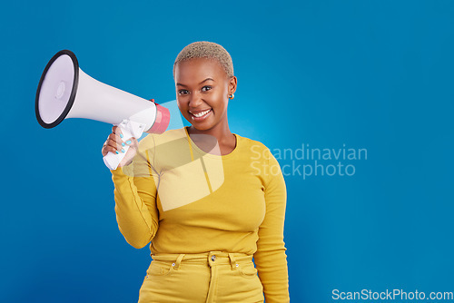 Image of Black woman, megaphone and portrait, protest and voice, freedom of speech and activism on blue background. Female smile, broadcast and speak out, rally and mockup, loudspeaker with opinion in studio