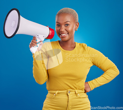 Image of Black woman, megaphone and smile, portrait and voice, freedom of speech and activism on blue background. Happy female, broadcast and speak out, rally and protest, loudspeaker with opinion in studio