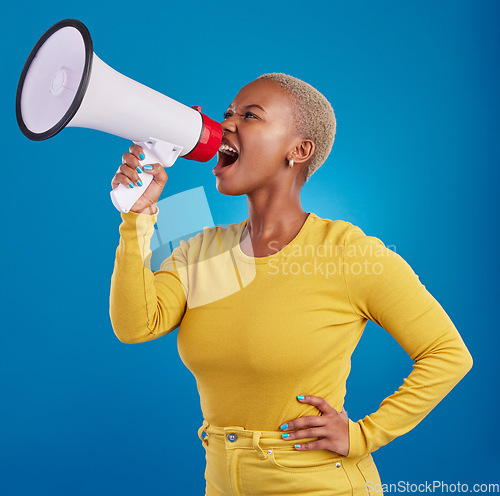Image of Megaphone, angry and screaming black woman in studio for message, broadcast or vote on blue background. Speaker, microphone and girl protest for change, democracy and justice, noise and womens rights