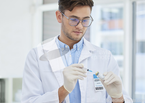 Image of Doctor, man and vaccine, healthcare and needle syringe with bottle, medicine and safety from virus and research. Serious male in clinic, health insurance and medical professional to prevent disease