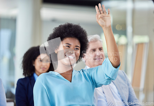 Image of Black woman, presentation and question in business, answer or FAQ in team meeting from audience in seminar. African female with hands raised in staff training, planning or strategy in crowd workshop