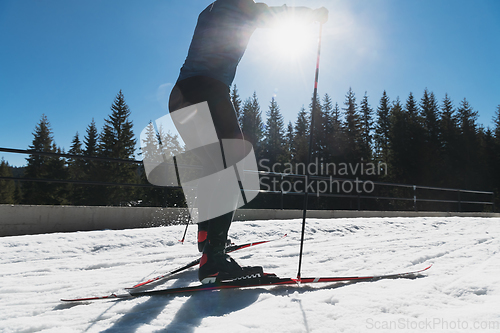 Image of Nordic skiing or Cross-country skiing classic technique practiced by man in a beautiful panoramic trail at morning.