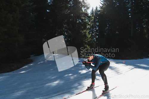 Image of Nordic skiing or Cross-country skiing classic technique practiced by man in a beautiful panoramic trail at morning.