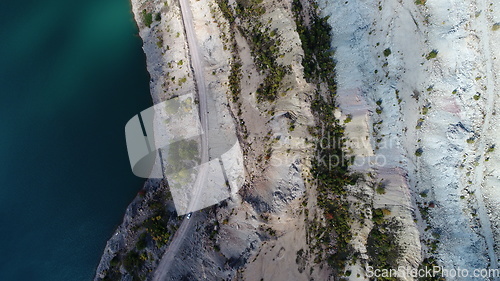 Image of Turquoise water in a mountain forest lake with pine trees. Aerial view of blue lake and green forests. View on the lake between mountain forest. Over crystal clear mountain lake water. Fresh water