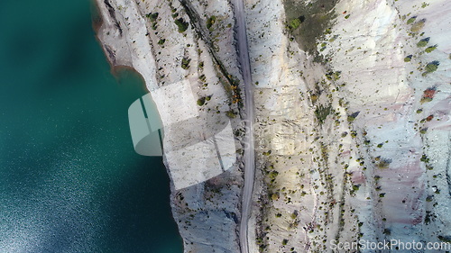 Image of Turquoise water in a mountain forest lake with pine trees. Aerial view of blue lake and green forests. View on the lake between mountain forest. Over crystal clear mountain lake water. Fresh water