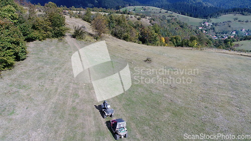 Image of Aerial drone view of ATV quads on a dirt trail in forests. Off-road group team club enthusiasts having fun while driving countryside roads.