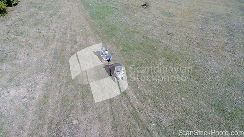 Image of Aerial drone view of ATV quads on a dirt trail in forests. Off-road group team club enthusiasts having fun while driving countryside roads.