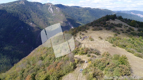 Image of Aerial drone view of ATV quads on a dirt trail in forests. Off-road group team club enthusiasts having fun while driving countryside roads.