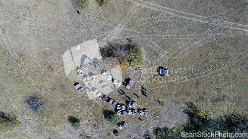 Image of Aerial drone view of ATV quads on a dirt trail in forests. Off-road group team club enthusiasts having fun while driving countryside roads.