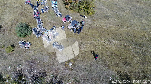 Image of Aerial drone view of ATV quads on a dirt trail in forests. Off-road group team club enthusiasts having fun while driving countryside roads.