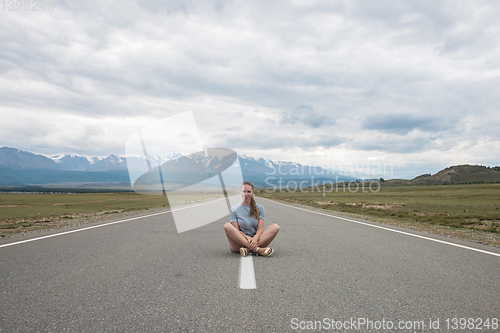 Image of Woman sitting on the road