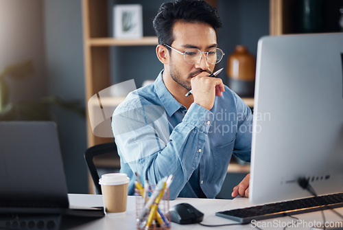 Image of Serious, business man and thinking on computer in office, internet research and website. Focused male employee, desktop and solution of ideas, planning decision and review strategy, project or vision