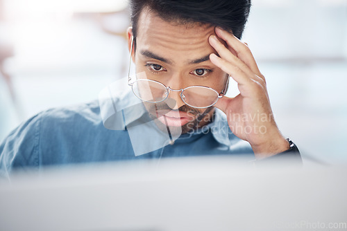 Image of Asian man, frustrated and tired with laptop in office for glitch, problem or anxiety for proposal, idea or burnout. Businessman, computer and thinking with stress, depressed or headache for 404 error