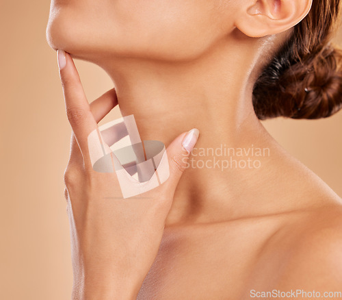 Image of Skincare, beauty and neck of a woman with a glow isolated on a brown background in a studio. Wellness, health and a girl feeling and touching skin for satisfaction, grooming and care for anti aging