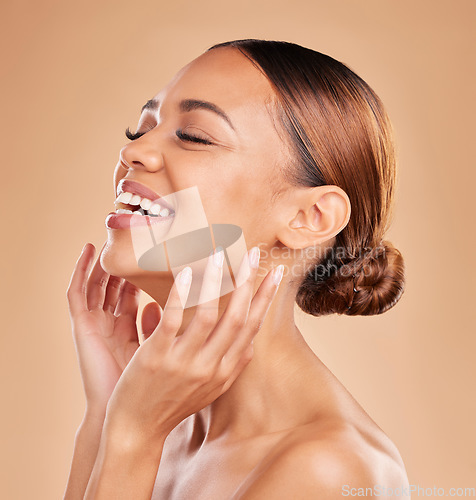 Image of Smile, beauty and a woman with hands on face for skin care glow and shine in studio on brown background. Aesthetic female model laugh and satisfied with spa facial, dermatology cosmetic and wellness