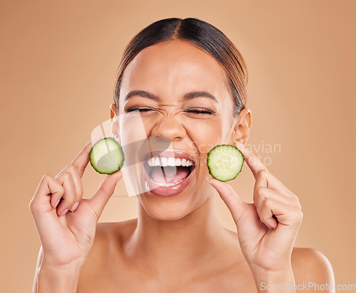 Image of Skincare, cucumber and face of woman with excited smile for wellness, facial treatment and natural cosmetics. Beauty, spa aesthetic and happy girl with fruit for detox, vitamin c and health in studio