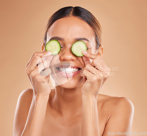 Image of Skincare, cucumber on eyes and face of woman with smile for wellness, facial treatment and natural cosmetics. Beauty, spa aesthetic and happy girl with vegetable for detox, vitamin c and dermatology