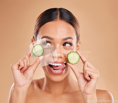 Image of Skincare, holding cucumber and face of woman with smile for wellness, facial treatment and natural cosmetics. Beauty, spa aesthetic and happy girl with fruit for detox, vitamin c and health in studio