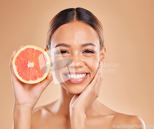 Image of Skincare, grapefruit and face of woman with smile in studio for wellness, facial treatment and natural cosmetics. Beauty, spa aesthetic and happy girl with fruit for detox, vitamin c and healthy skin