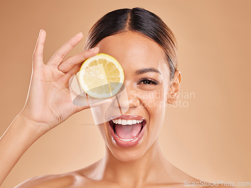 Image of Lemon, skincare and face of woman with excited smile in studio for wellness, facial treatment and natural cosmetics. Beauty, spa and happy girl with fruit slice for detox, vitamin c and dermatology