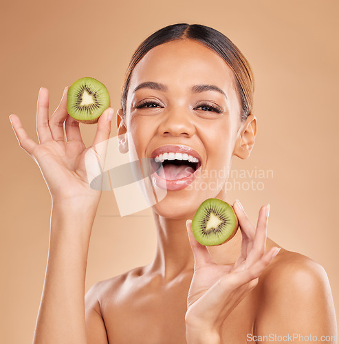 Image of Skincare, kiwi and portrait of woman with smile in studio for wellness, facial treatment and natural cosmetics. Beauty, organic spa and happy girl with fruit for detox, nutrients and healthy skin