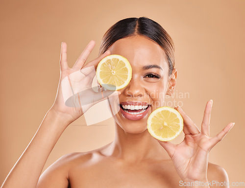 Image of Skincare, lemon in hands and face of woman with smile for wellness, facial treatment and natural cosmetics. Beauty, spa and happy girl with fruit slice for citrus detox, vitamin c and dermatology