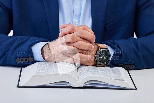 Image of Closeup, hands and man with bible, praying and guidance with higher power, hope and spiritual. Zoom, male and Christian with holy book, scripture and religious with faith, Catholic text and belief