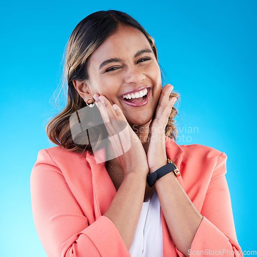 Image of Excited, hands on face and portrait of woman in studio with surprise, good news and happiness expression. Wow, emoji reaction and Indian girl for success, celebration and happy on blue background