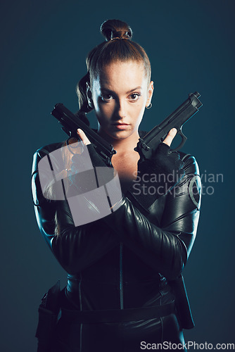 Image of Woman, gun and assassin in studio portrait for costume, action or cyberpunk clothes. Girl, pistol and leather fashion for crime, gangster and futuristic spy with danger or future aesthetic with ninja