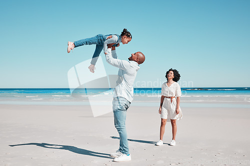 Image of Playing, happy and child with parents at the beach for bonding, quality time and relaxation. Smile, family and playful girl kid with dad and mother at the ocean for holiday, happiness and summer