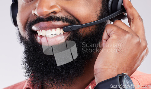 Image of Closeup, consultant and black man with headset, telemarketing and explain process against a studio background. Zoom, male employee and happy agent with headphones, customer service and tech support