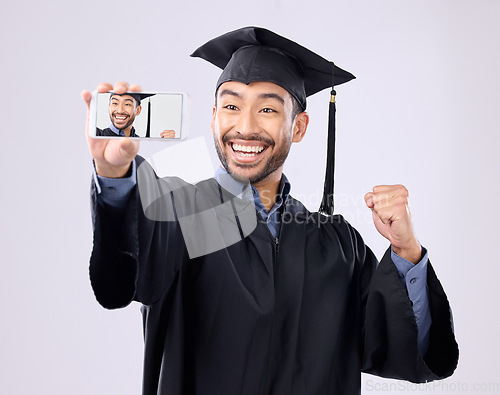 Image of Asian man, selfie and smile for graduation, scholarship or diploma against a white studio background. Happy male graduate smiling for profile picture, vlog or photo in memory of milestone achievement