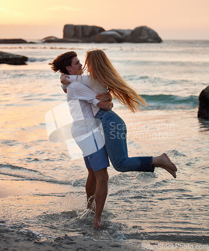 Image of Couple in ocean, freedom and hug, love and commitment in relationship, man swing woman with adventure at beach. Trust, partnership and care with people outdoor, romance and happiness at sunset