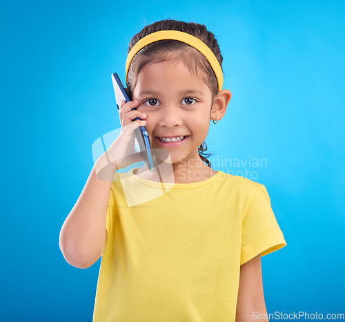 Image of Phone call, smile and portrait of child on blue background for talking, speaking and chatting online. Technology, communication mockup and face of happy girl in conversation on smartphone in studio